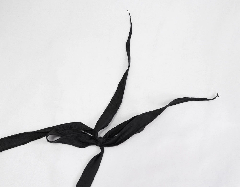 Close-up detail of black gothic bikini top halter tie strap showing knot and fabric texture