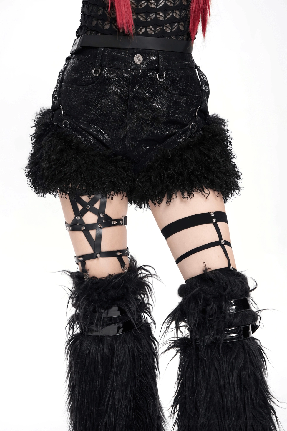 Styled flat lay of black gothic shorts with complementary goth accessories and alternative fashion elements