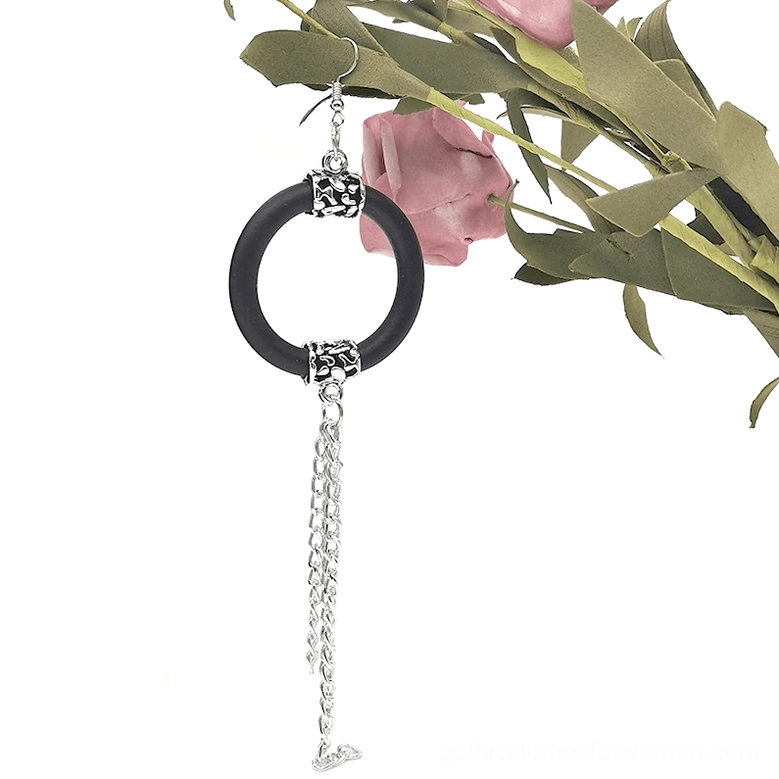 Black rubber drop earring with single silver chain tassel, front flat lay, gothic jewelry detail shot