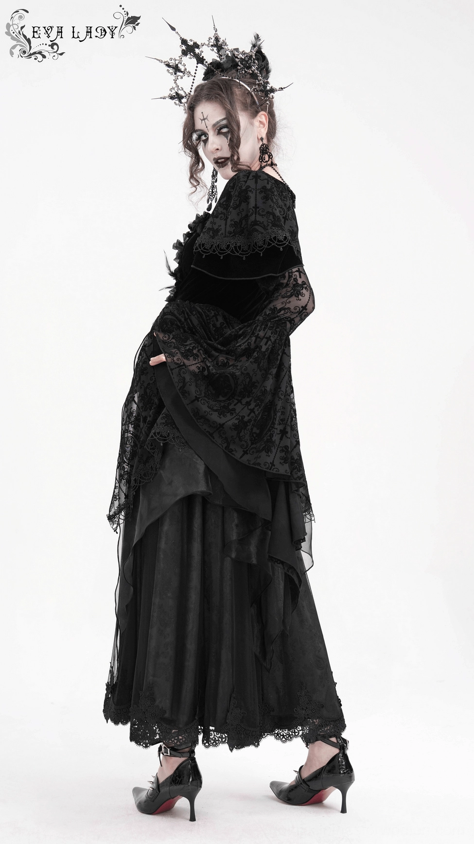 Black gothic lace dress side angle showing bell sleeves, mixed fabric construction, and dramatic floor-length silhouette