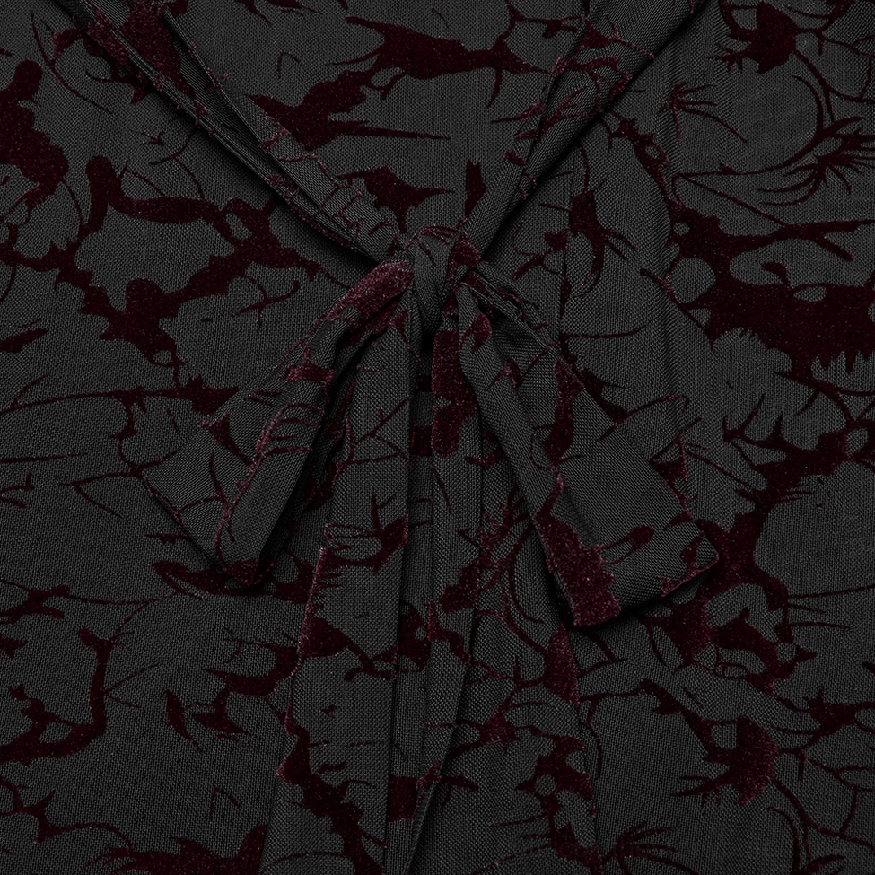 Gothic dress waist sash close-up showing tied fabric with dark red vine-printed mesh overlay detail