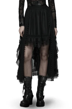 Black gothic layered high-low mesh skirt full front view with removable steel waist structure worn over fishnet stockings