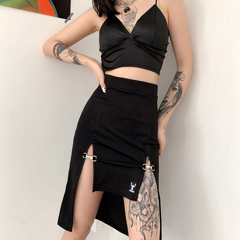Three-quarter side view of gothic black midi skirt on model with cropped black top styling