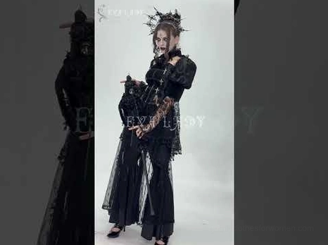 Gothic lace bell-bottom pants worn by female model in dark themed photoshoot as part of complete goth formal outfit