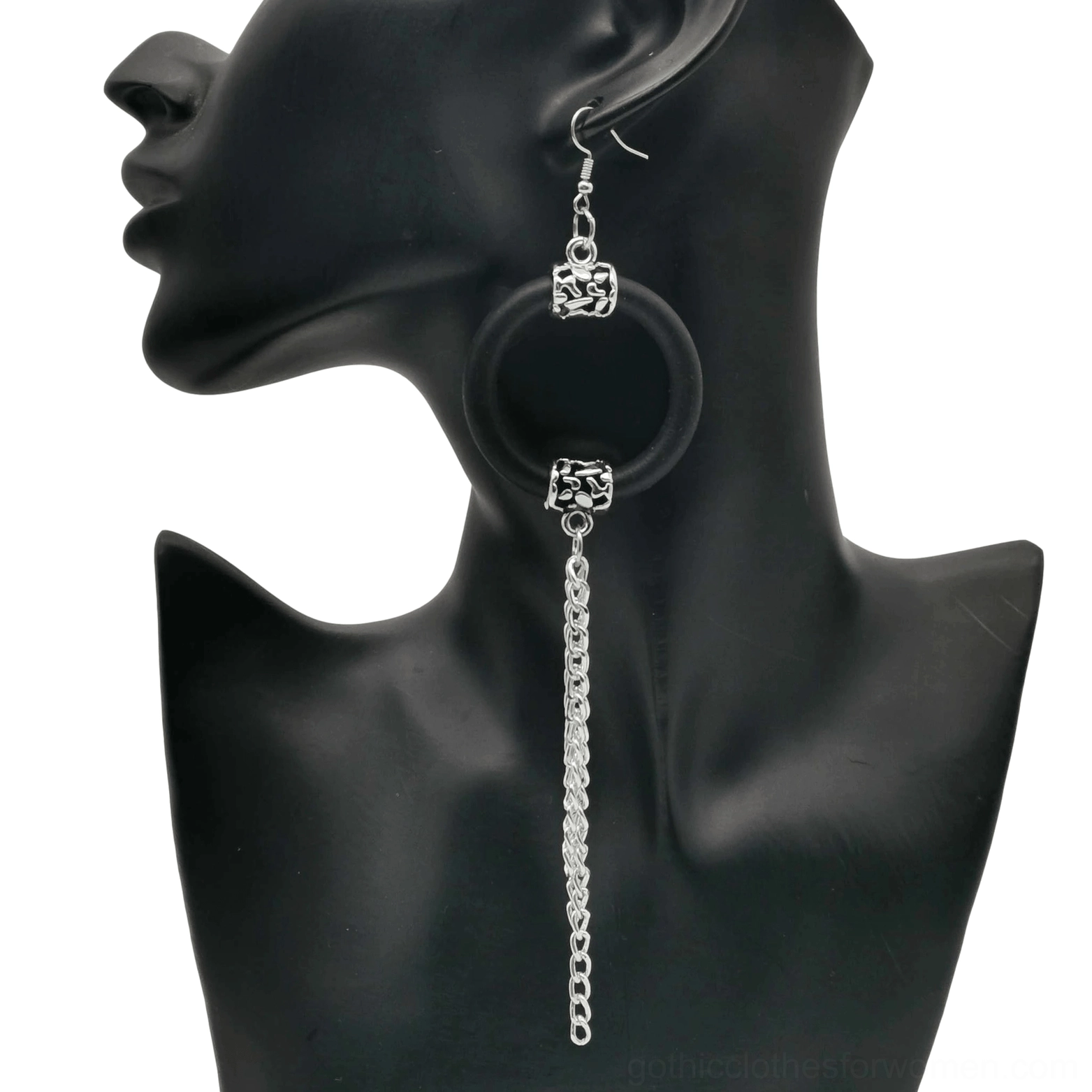 Black rubber hoop drop earrings with silver chain tassels, side view on jewelry mannequin, showcasing gothic statement jewelry