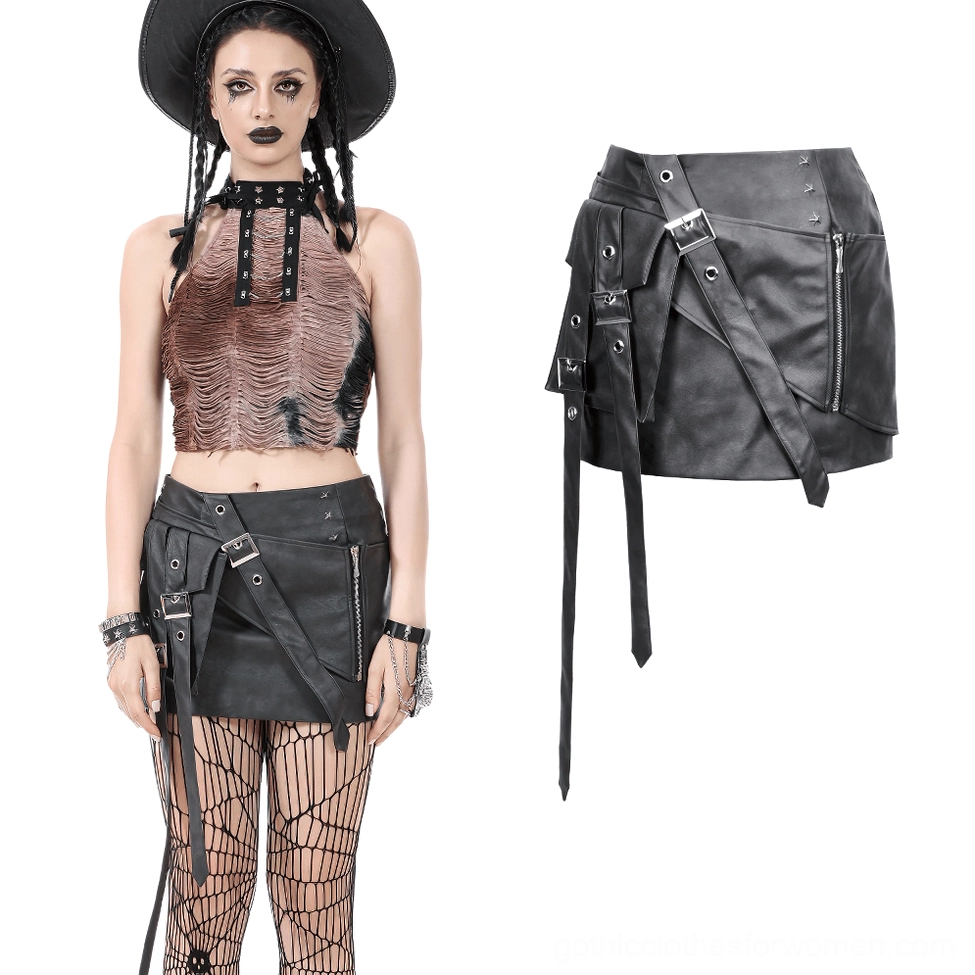 Gothic punk black faux leather skirt styled with crop top and decorative belt straps worn by model with wide brim hat
