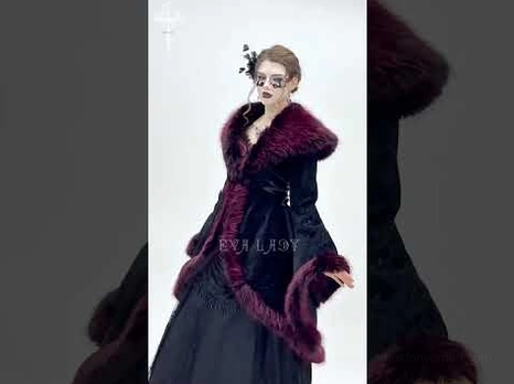 Rear flat lay perspective of black velvet gothic coat showing side lace-up corset details, fur-trimmed hemline, and structured back silhouette