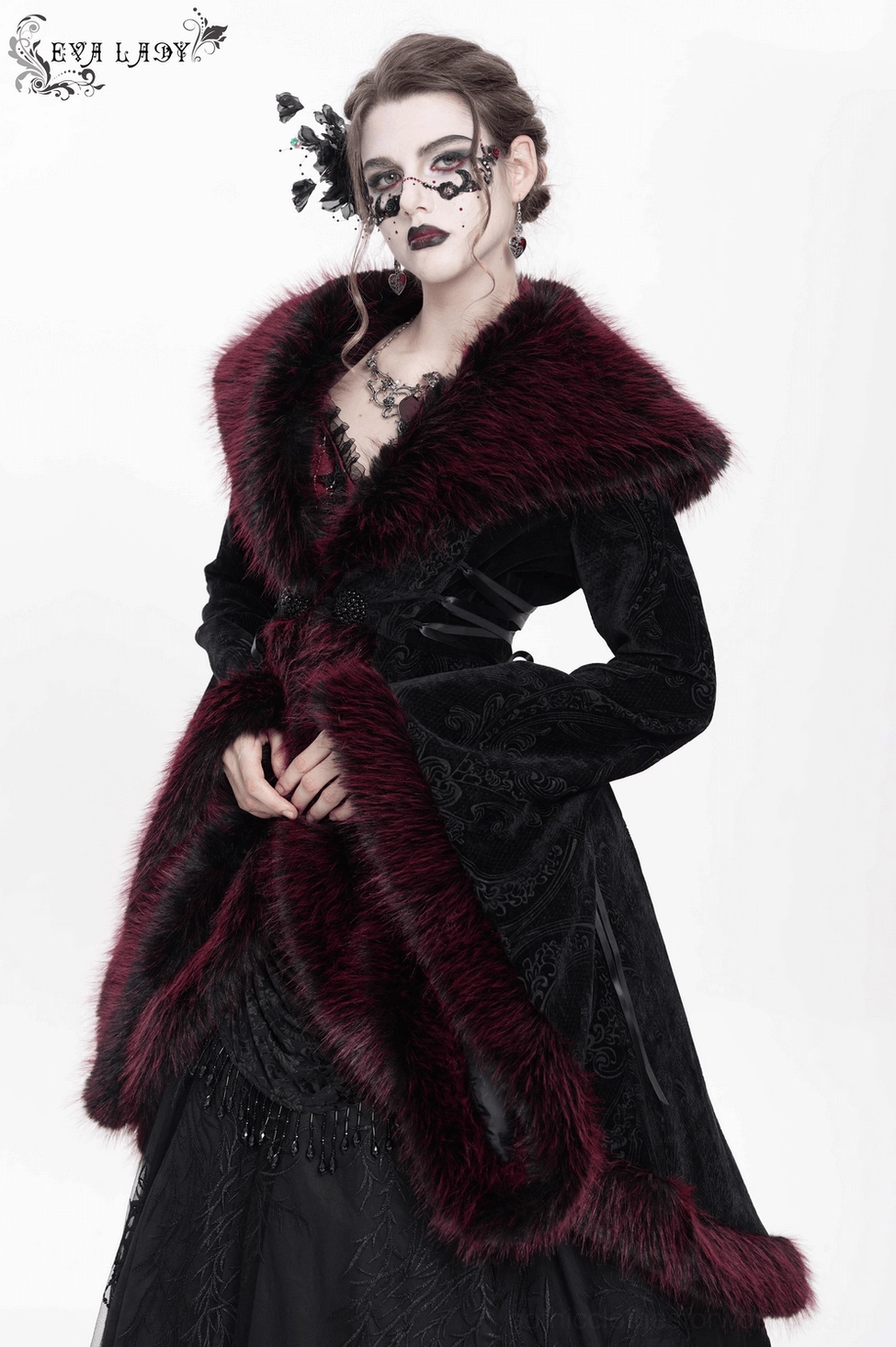 Overhead flat lay view of gothic black velvet coat showing overall garment construction, lace details, and burgundy faux fur placement