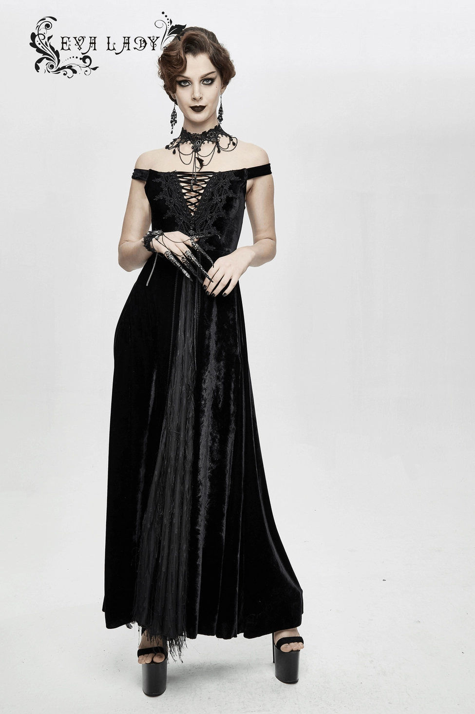 Gothic black velvet sleeveless floor-length dress with lace-up bodice and dramatic maxi hem, elegant product shot on white background