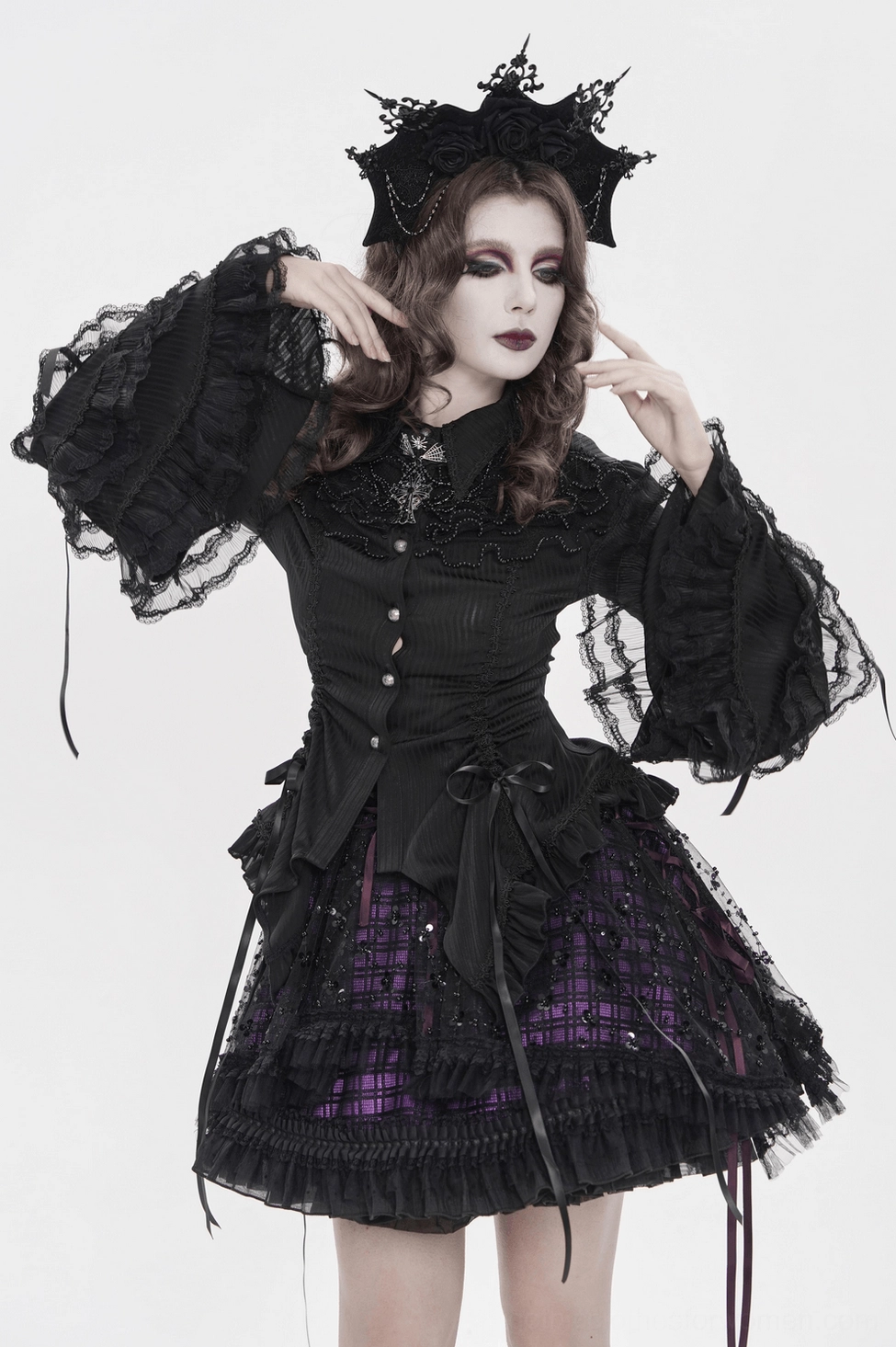 Alternative fashion styling perspective of gothic Victorian lace blouse with modern accessories