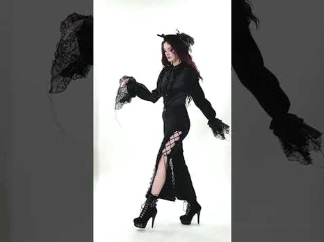 Gothic blouse styled with black high-slit skirt and heeled boots - alternative fashion styling inspiration