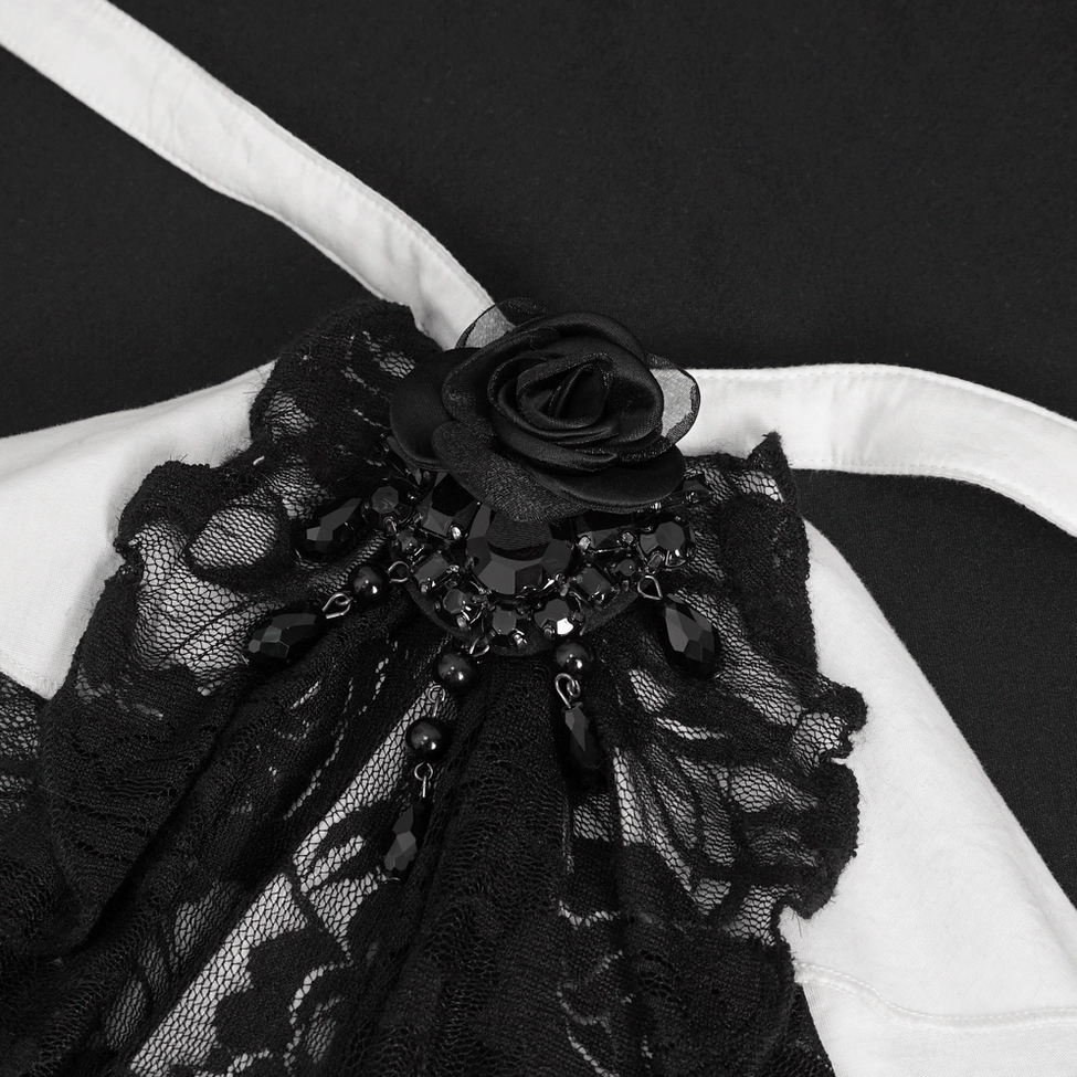 Close-up view of white gothic blouse's bell sleeve cuff with black lace trim and ruffled edge detail