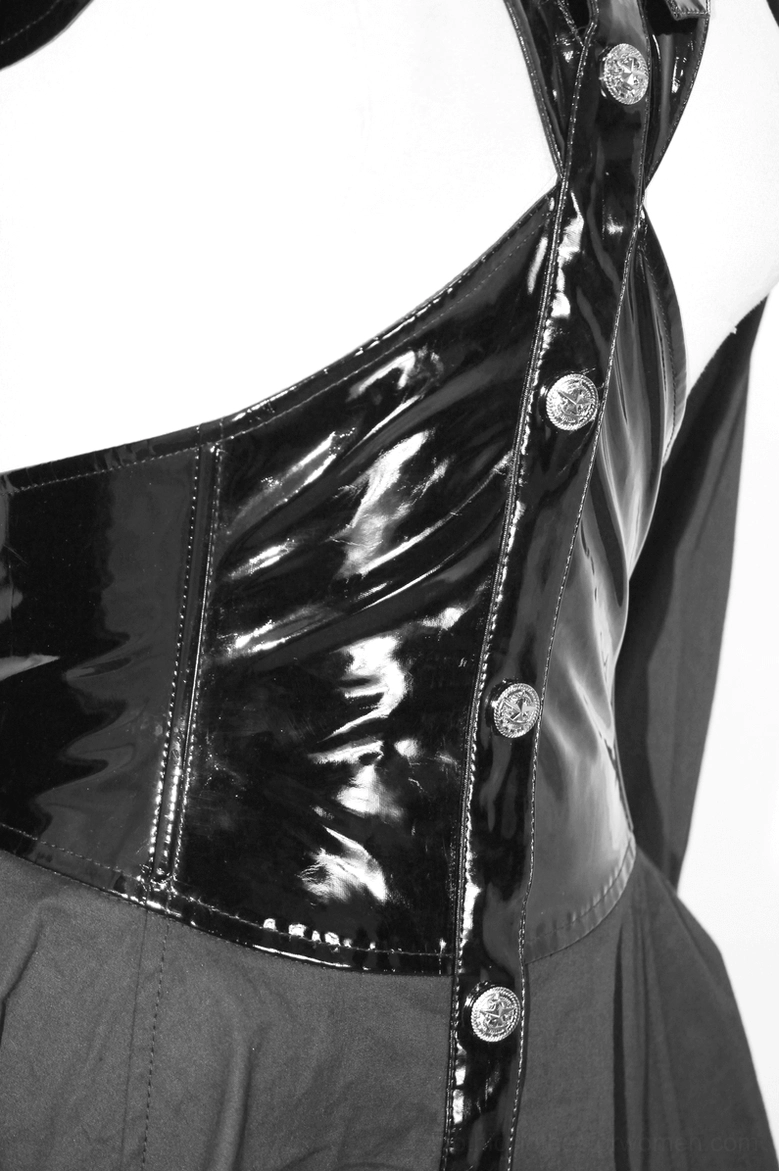 Detailed shot - hollow bust panel with shiny patent leather and metal buttons