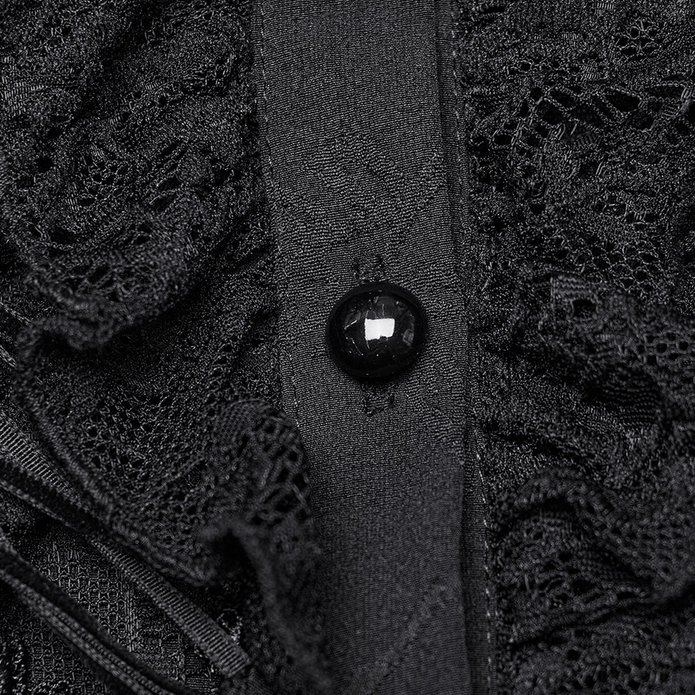 Black glossy button and floral lace panel close-up on gothic women's blouse