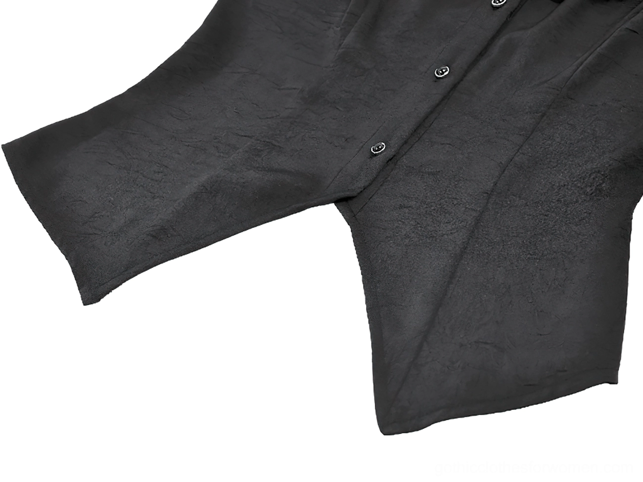 Close-up flat lay detail of black gothic ruffle blouse front button placket, matte black fabric finish and tailored cut