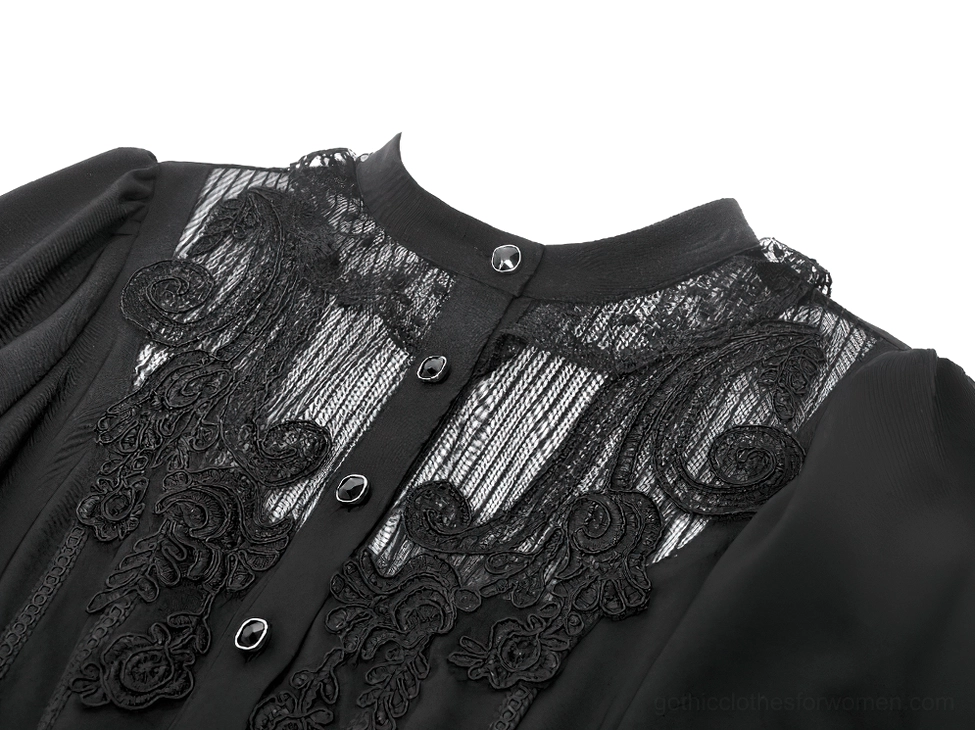 Close-up detail of black gothic blouse floral lace applique on sheer mesh chest panel and ruffled collar