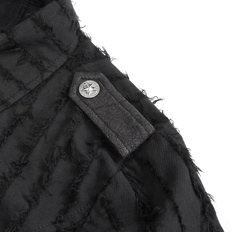 Close-up detail of black gothic blouse shoulder epaulet with embossed metal button and frayed fabric texture