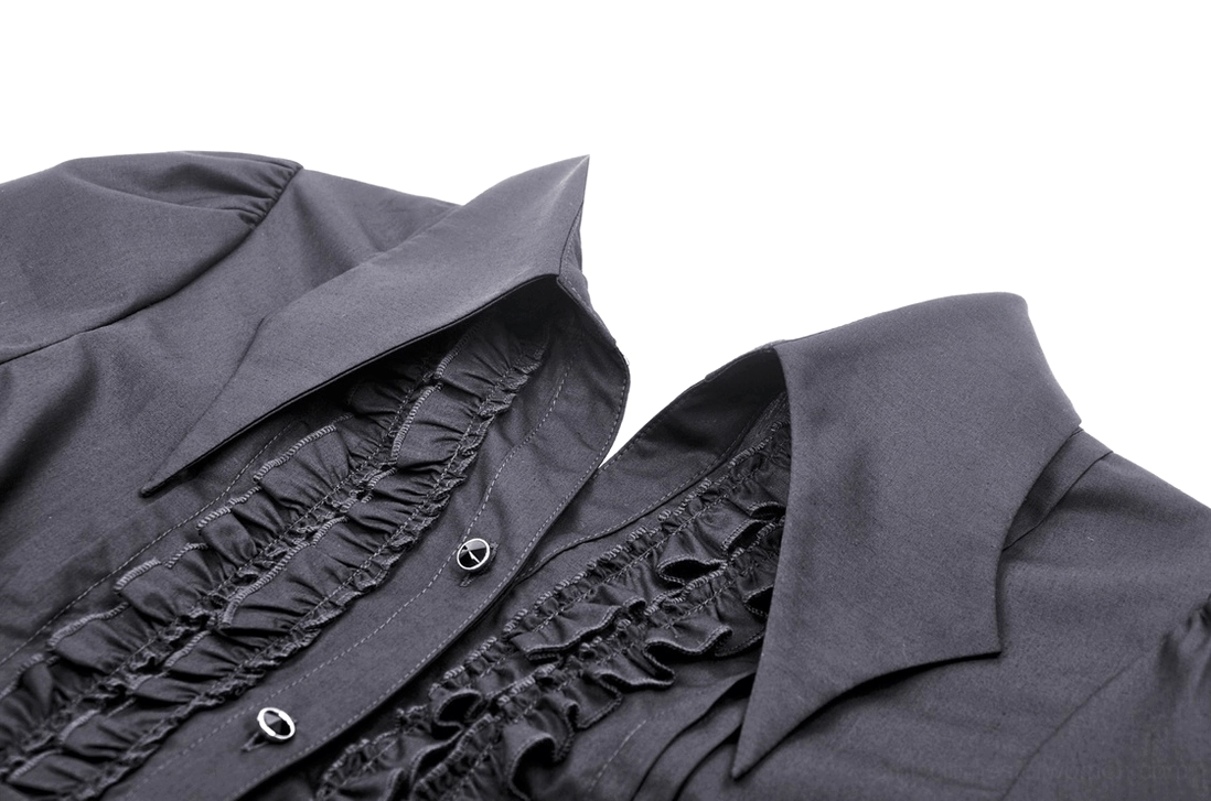 Close-up detail of gothic blouse pointed collar and upper front placket showing ruffled fabric trim and antique metal button finishes