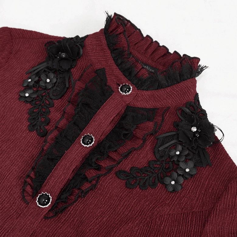 Close-up detail of wine red gothic blouse collar featuring black floral appliqué, ruffled lace trim, and decorative buttons
