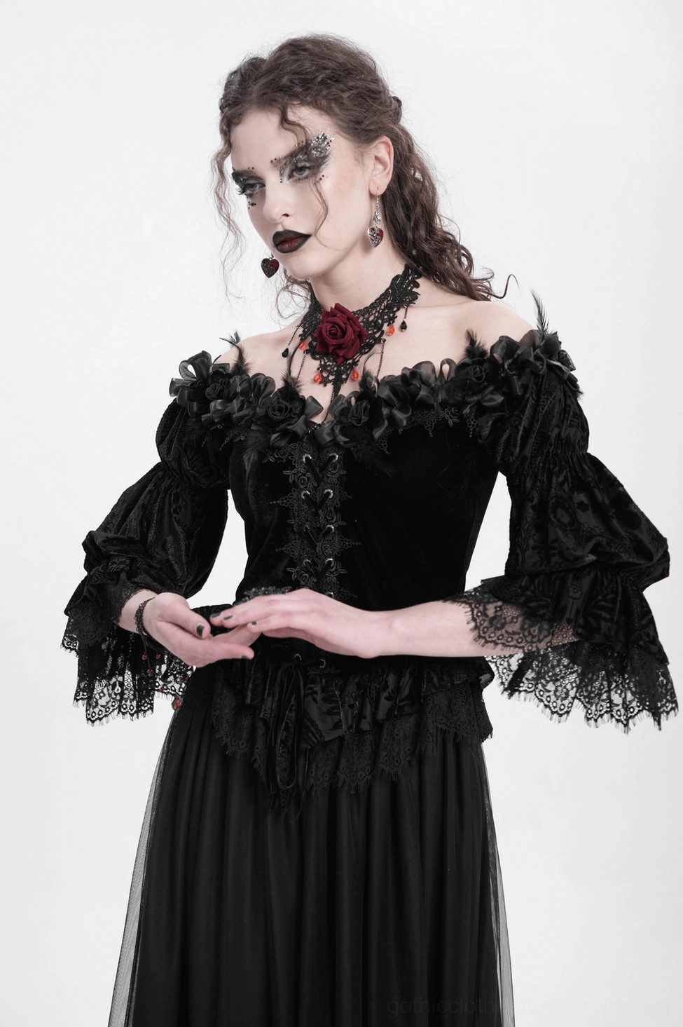 Black gothic blouse product detail showing complete front view with all design elements: lace-up, roses, ruffles, and asymmetrical hem