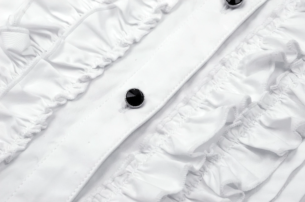 Detailed macro photography of gothic blouse front placket featuring double ruffled trim and black metal button hardware