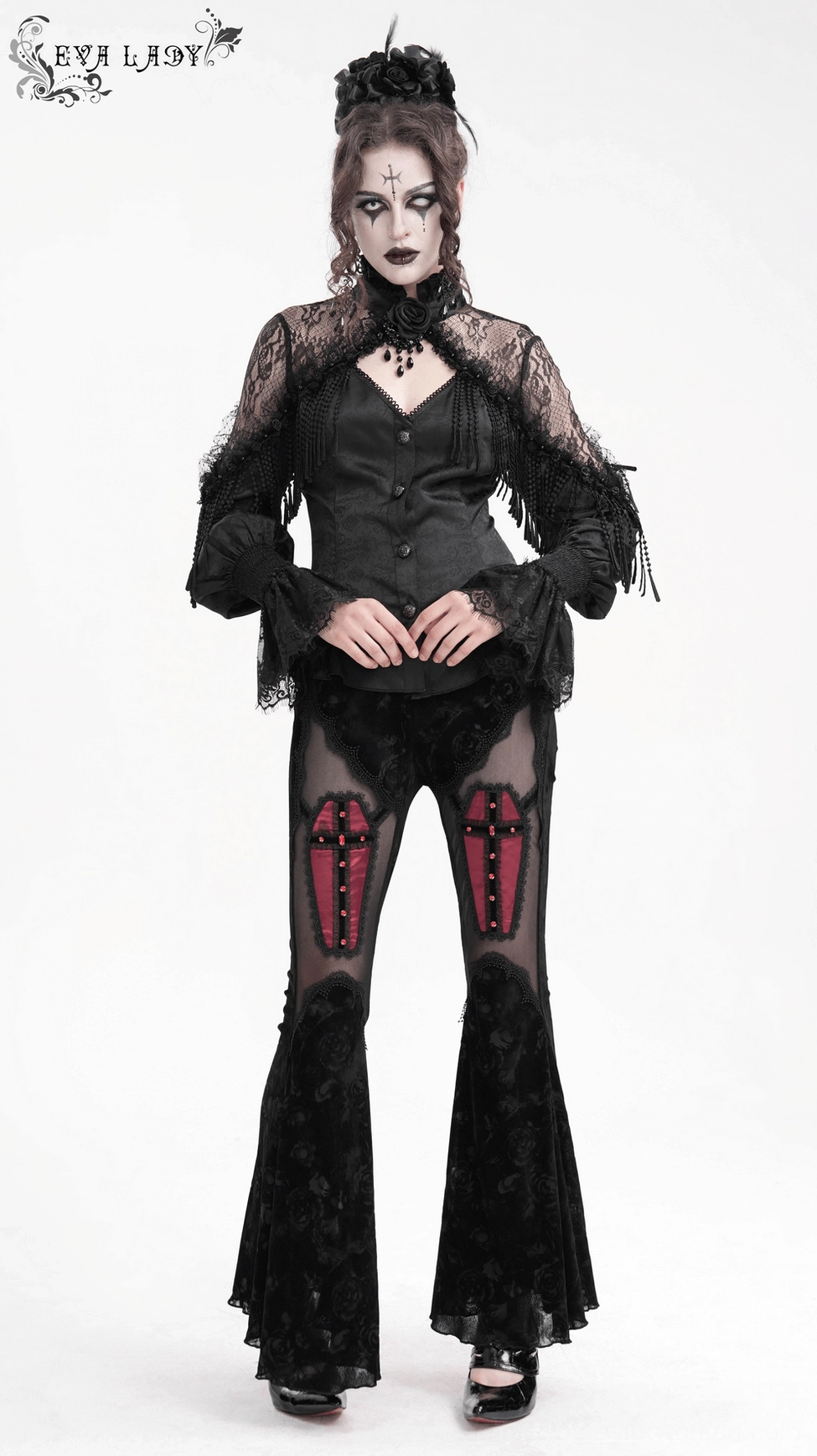 Flat lay of Victorian gothic blouse showing complete garment with tassel details, lace cuffs, and button embellishments