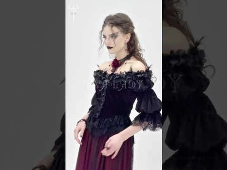 Flat lay back view of gothic off-shoulder blouse displaying asymmetrical hemline and delicate lace trim details
