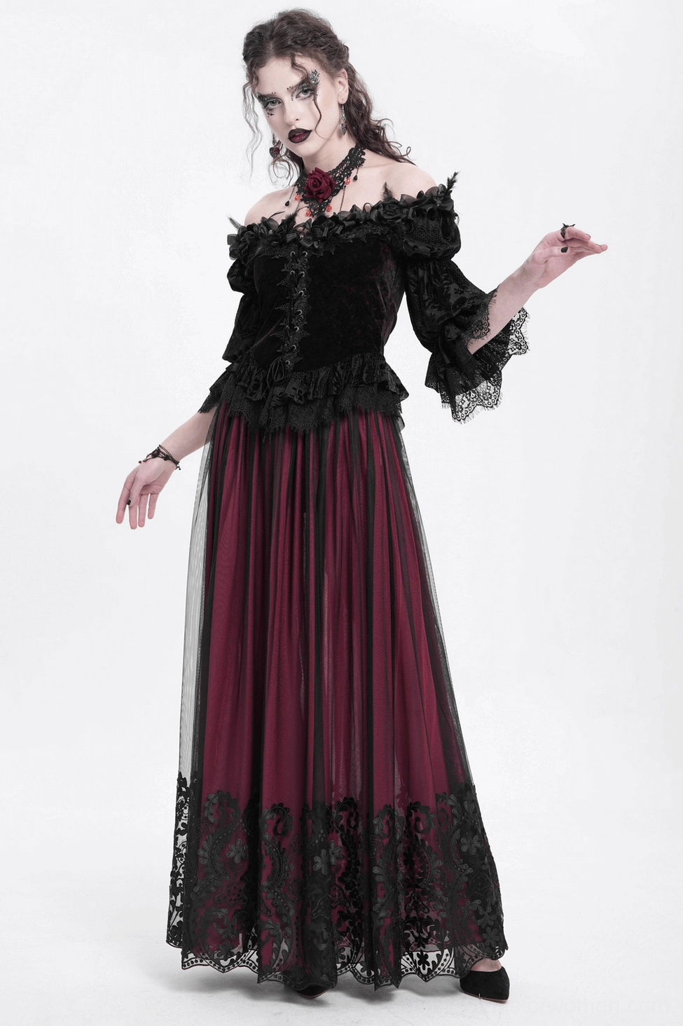 Detail shot of gothic wine red velvet blouse displaying floral lace accents and puffed sleeve ruffles