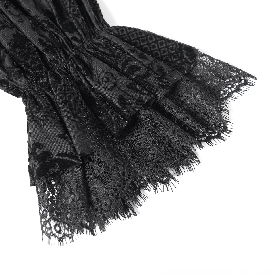 Black gothic velvet blouse detail shot highlighting lace-up front mechanism with metal eyelets and intricate lace embroidery