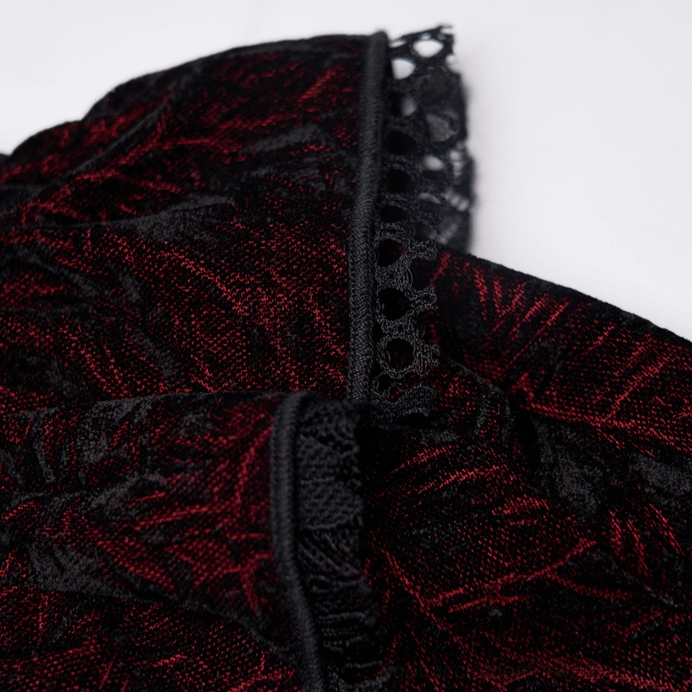 Close-up detail of black lace eyelet trim on burgundy velvet gothic blouse cuff