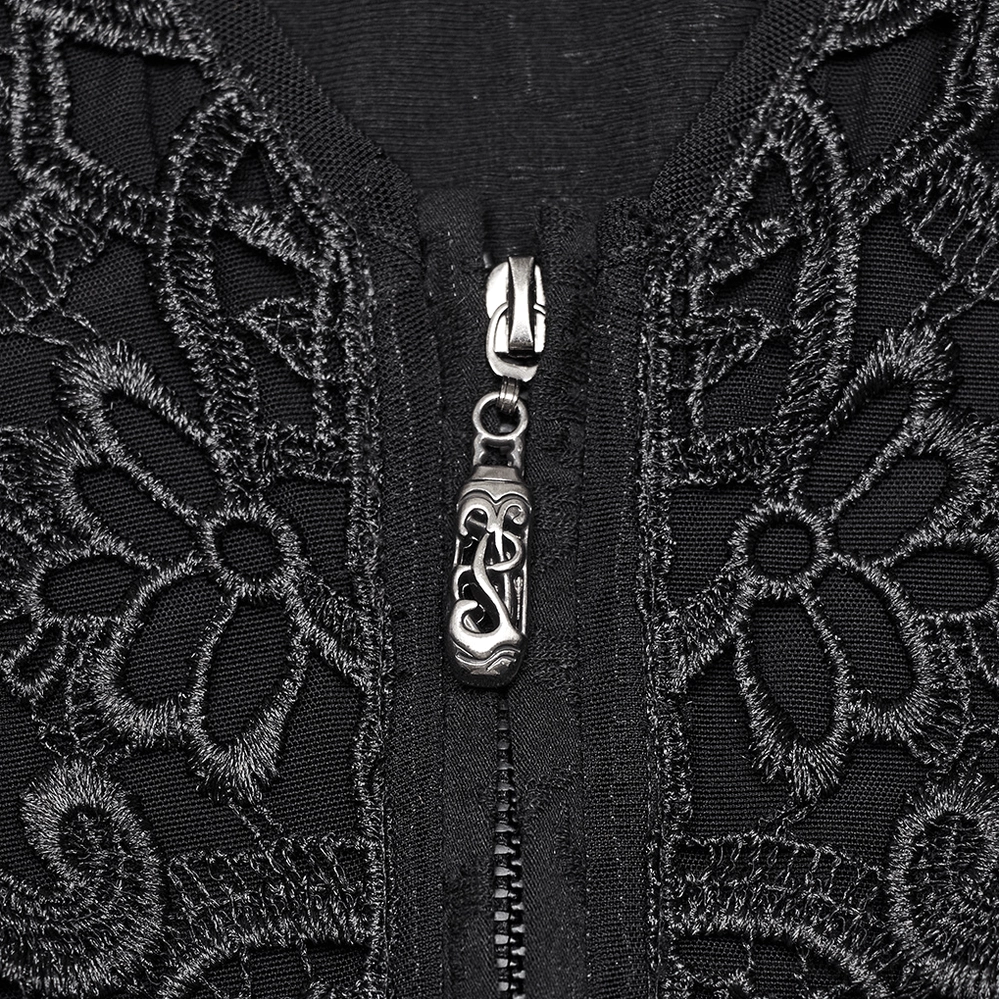 Close-up detail of black gothic blouse front featuring vintage-style metal zipper with engraved gothic pendant and floral lace applique panel