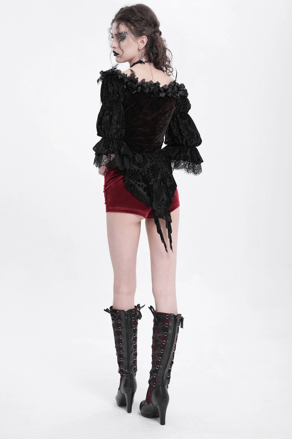 Detail shot of gothic velvet blouse showing wine red fabric sheen and lace trim placement on off-shoulder neckline