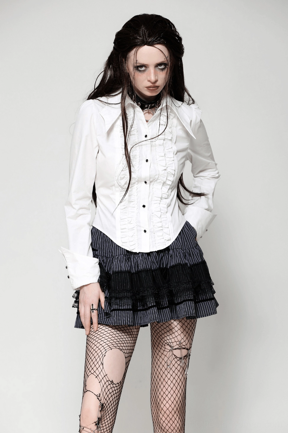 White gothic blouse front detail emphasizing double ruffled trim construction and premium black metal buttons