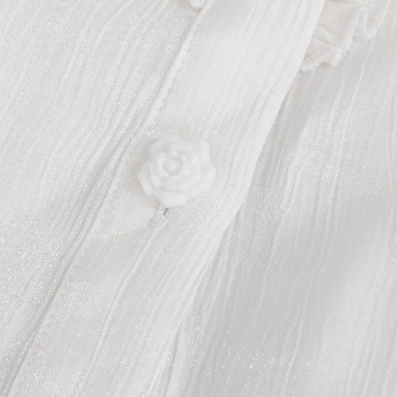 Close-up detail of white gothic blouse front placket featuring rose-shaped button and wrinkled sheer fabric with delicate gathering