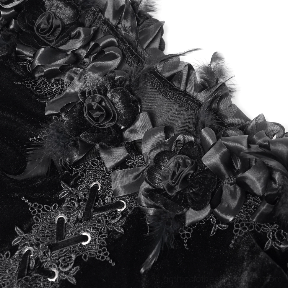 Close-up macro detail shot of gothic blouse neckline showing satin rose embellishments, feather trims, and lace embroidery on dark velvet
