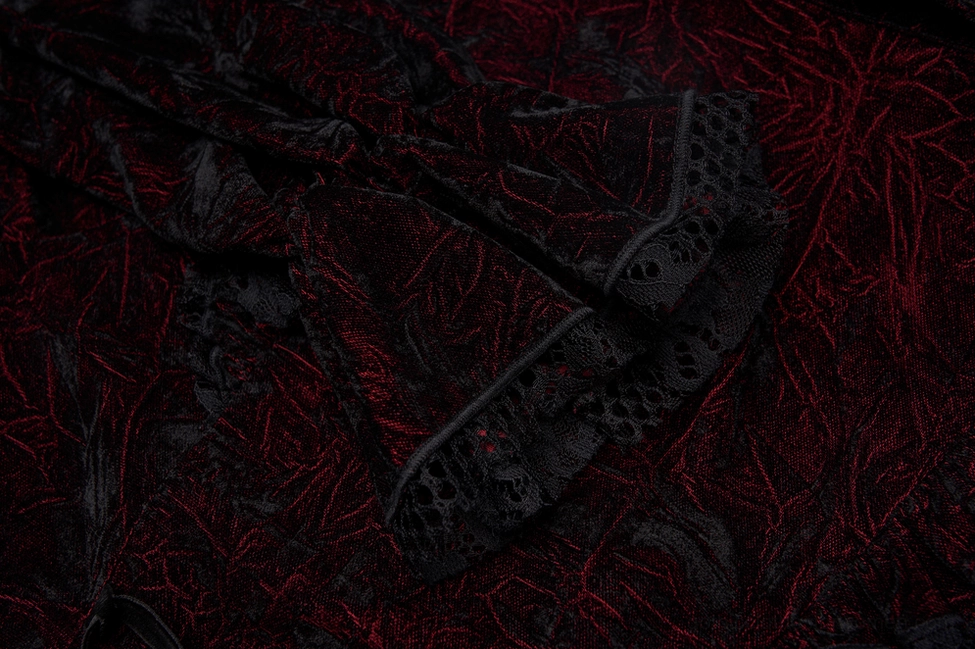 Close-up detail of black lace-trimmed ruffle on burgundy velvet gothic blouse