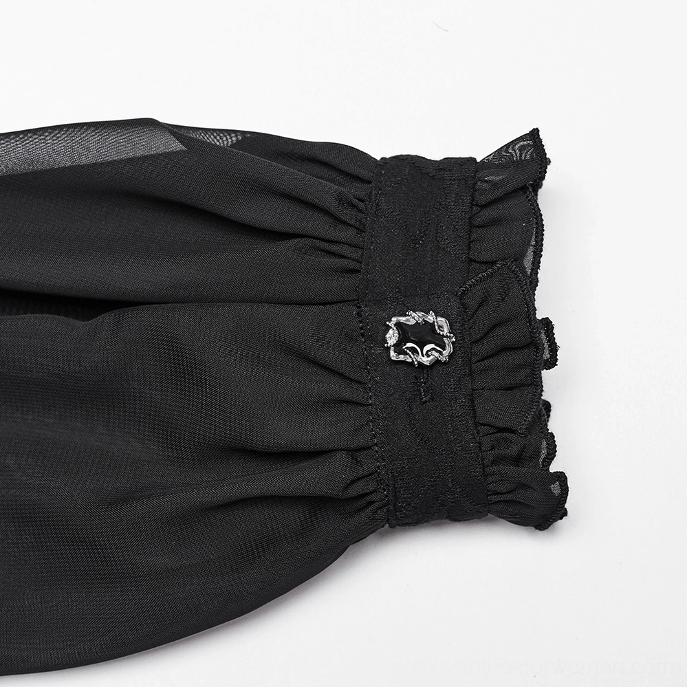 Close-up detail of black gothic blouse cuff showing ruffled elastic edge, vintage metal buckle accent, and sheer chiffon fabric