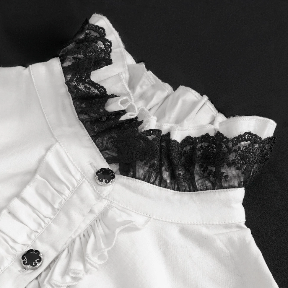 Detailed close-up of ruffled black lace collar with vintage decorative buttons on white gothic blouse