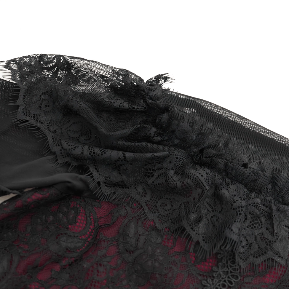 Top-down close-up of gothic blouse shoulder detail showing frilled lace edges, soft ruffled trim, and cold shoulder cutout design