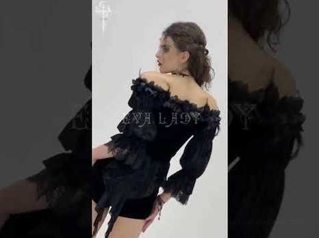 Gothic off-shoulder velvet blouse on model in side profile showing off-shoulder silhouette and ruffled lace details