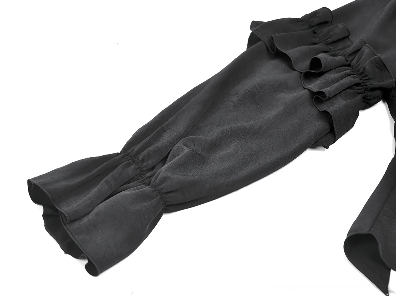 Macro detail view of gothic blouse layered ruffle cuffs and tailored sleeve hem, showing fabric texture and construction