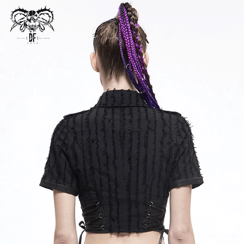 Textured detail shot of black gothic blouse frayed striped fabric and faux leather accents