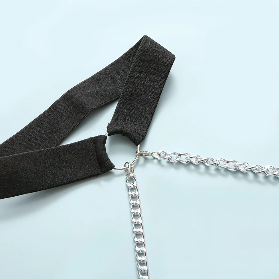 Black fabric strap with silver metal hardware close-up, gothic bodysuit chain assembly detail