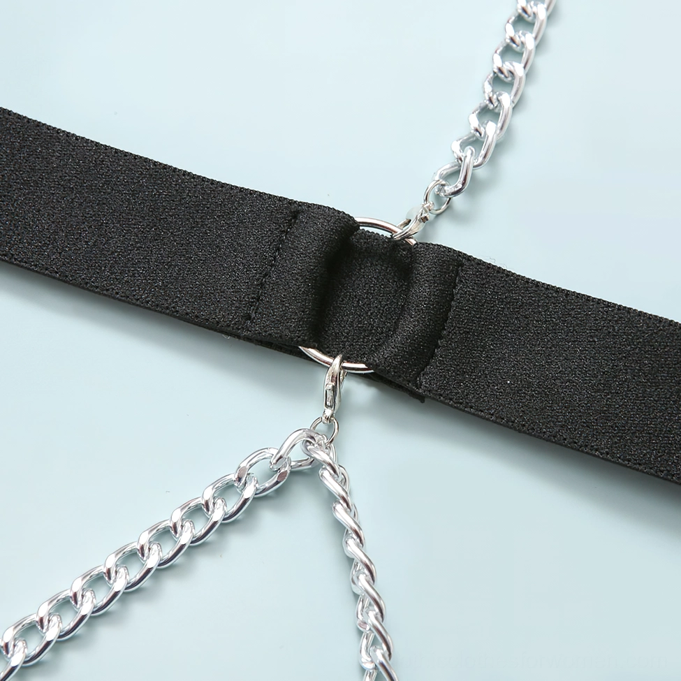 Close-up of black elastic strap and silver metal chain connector on gothic bodysuit, hardware detail
