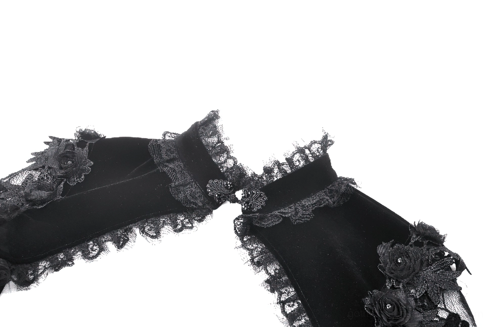 Close-up flat lay of black gothic bolero cuff decoration showing 3D floral appliques and ornate lace trim