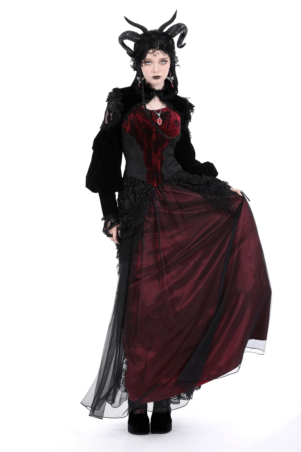 Black gothic bolero with ornate lace trim displayed on form showing architectural shoulder design and clasp closure