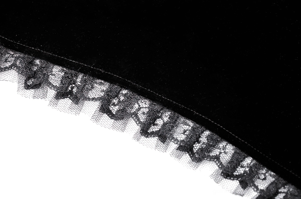 Black gothic bolero styling detail showing how lace and velvet layers create dimension and gothic elegance
