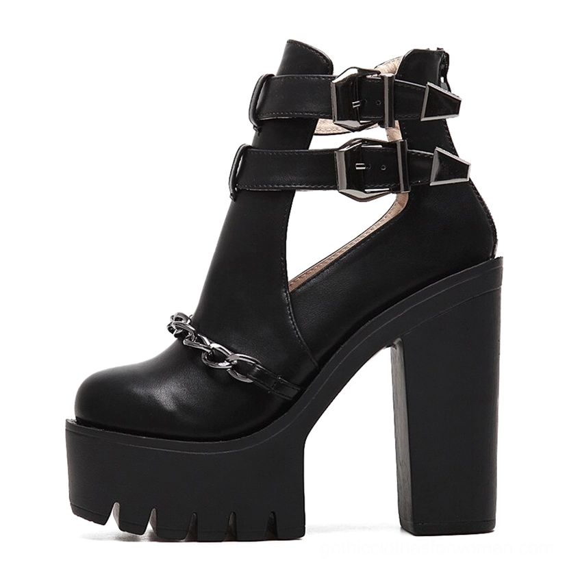 Black gothic platform boot side three-quarter view showcasing smooth PU leather and metal chain vamp detail