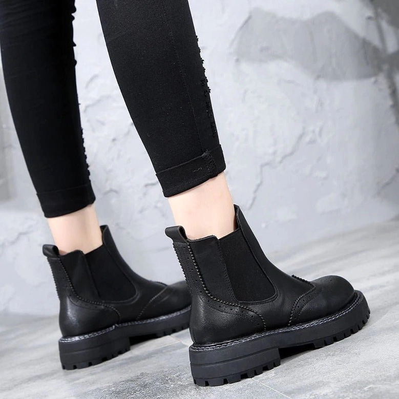 Chelsea platform boots architectural design with refined brogue perforations throughout