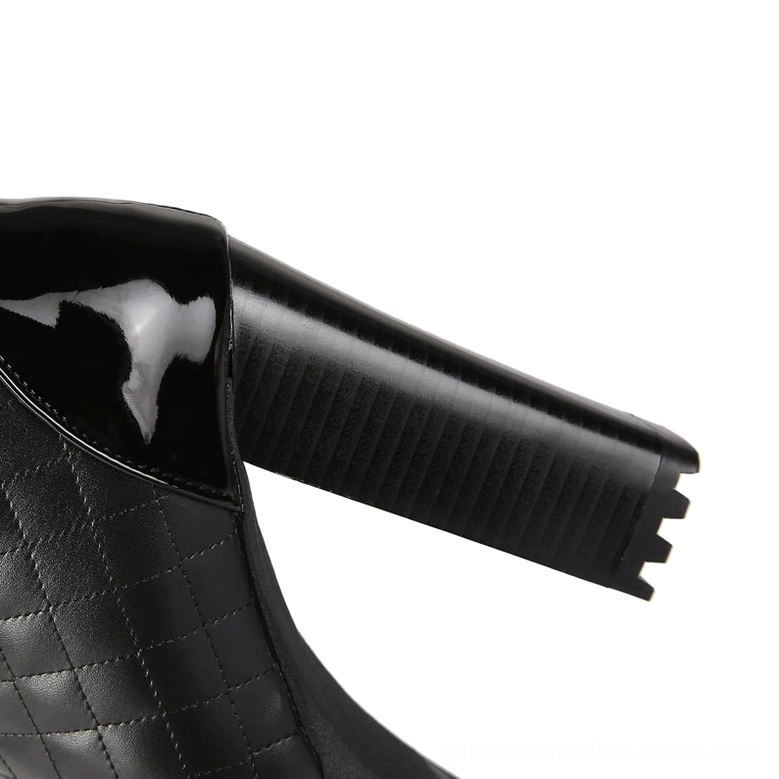 Chunky block heel and sole profile of black quilted gothic knee-high boots